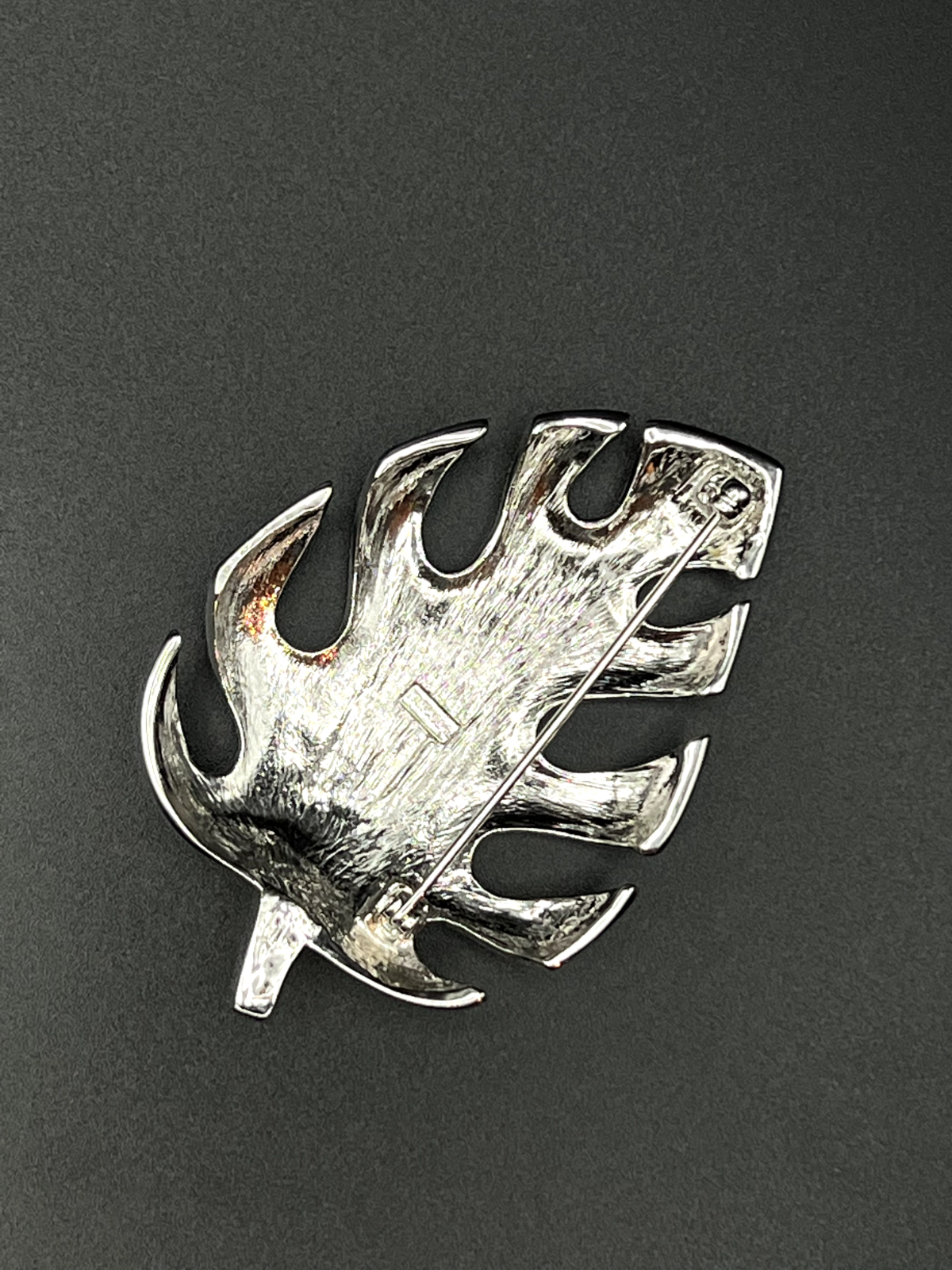 "TRIFARI signature on vintage silver leaf brooch pin close-up detail"